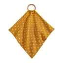 Yellow cotton bib with small white polka dots